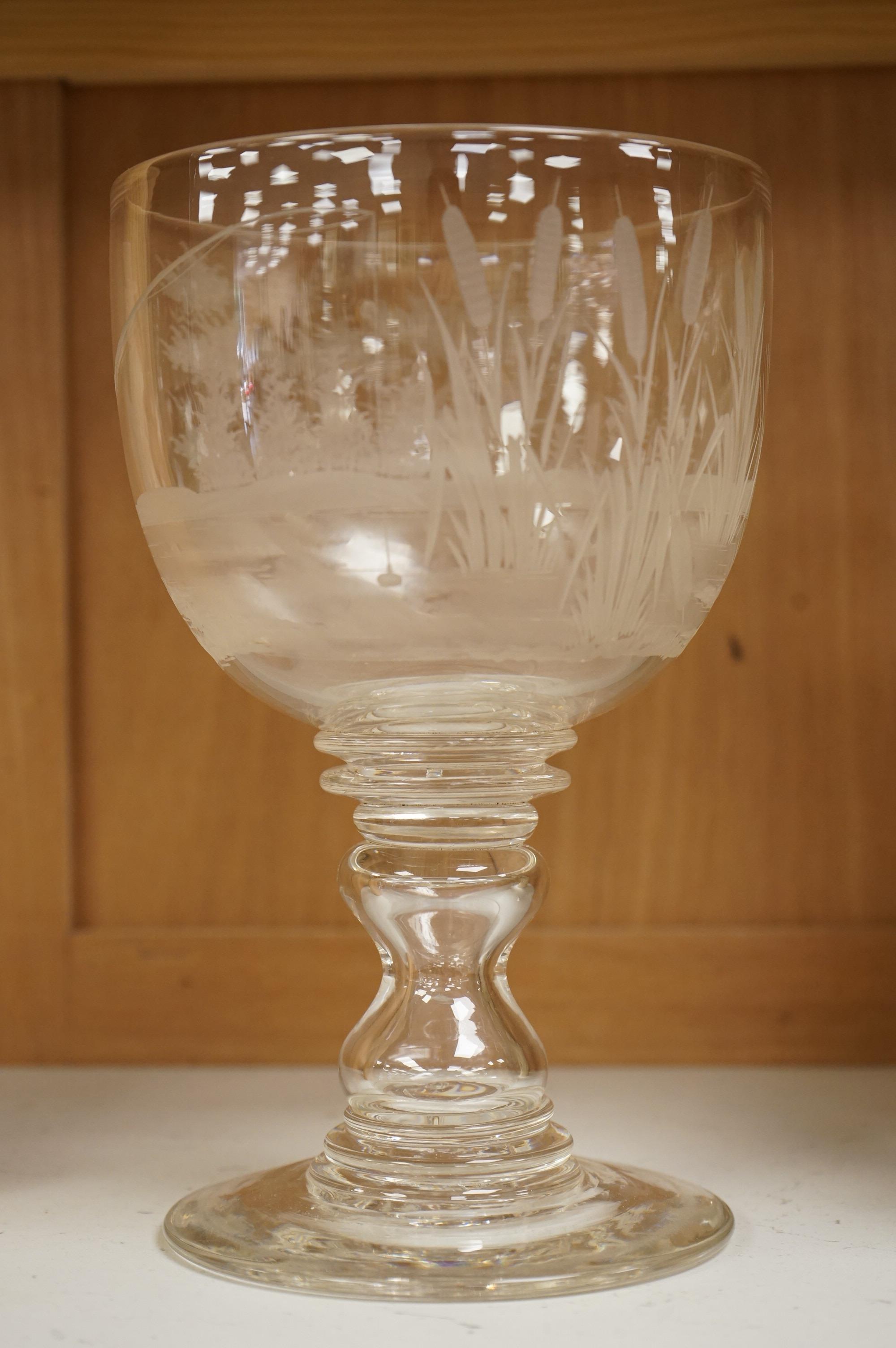 Fishing interest, a large mid 19th century glass goblet, engraved with a fisherman, bull rushes and foliage, 23cm high